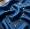 Pink Teardrop Station Chain. Soft pink teardrop crystals stationed along a delicate gold chain.
