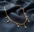 Marquise Crystal Drop Chain. Marquise-cut crystal drops hanging from a gold snake chain.