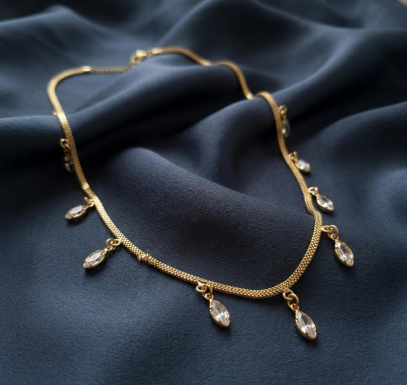 Marquise Crystal Drop Chain. Marquise-cut crystal drops hanging from a gold snake chain.