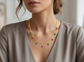 Ruby & Emerald Drop Chain. Alternating ruby-red and emerald-green drops on a fine gold chain.