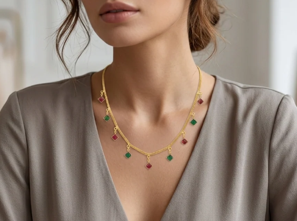 Ruby & Emerald Drop Chain. Alternating ruby-red and emerald-green drops on a fine gold chain.