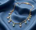 Mint & Crystal Heart Charm Chain. Mint and clear heart crystals hanging from a gold snake chain.