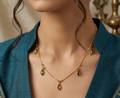 Green Teardrop Station Chain. Green teardrop stones stationed along a delicate gold chain.