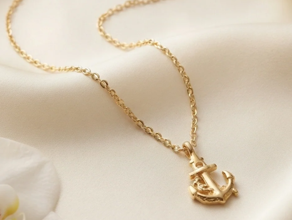 Gold Anchor Pendant Chain. A gold chain with a detailed anchor pendant.