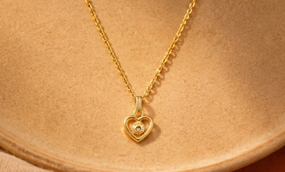 Gold Heart Pendant Chain. A gold chain with an open heart pendant and a single stone.