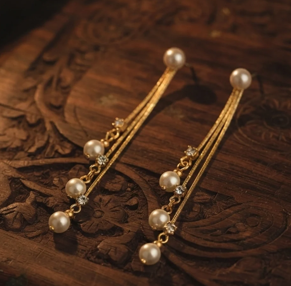 Pearl Bead Strand Drop Earrings. Gold chain strands with pearl beads and tiny crystal accents, from a pearl stud.
