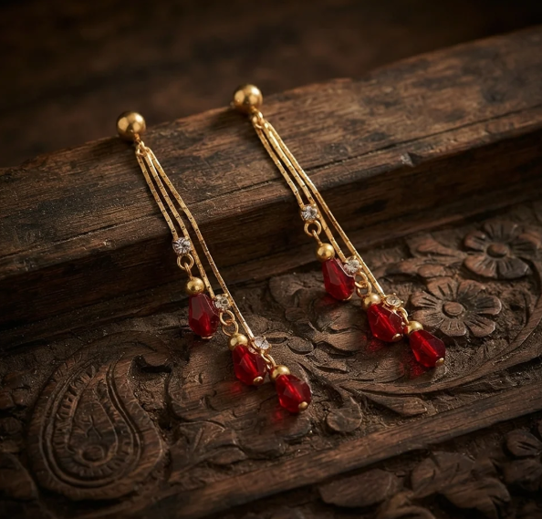 Three-Strand Crystal Bead Drop Earrings in Ruby Red. Three fine gold strands finished with faceted crystal beads that catch the light as you move.
