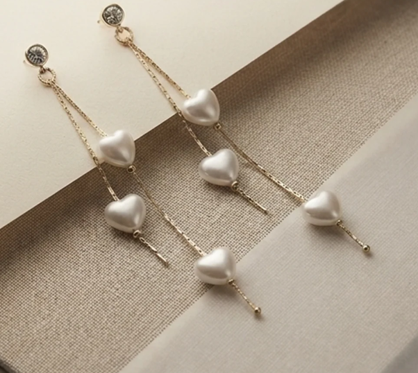 Heart Pearl Strand Drop Earrings. Pearl hearts on fine gold strands, hanging from a sparkling stud.