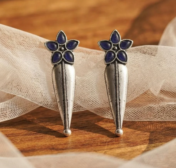 Flower Stud Silver Drop Earrings in Blue. Oxidised silver-finish earrings with a five-petal stone flower stud and a long textured teardrop drop with a beaded centre line.