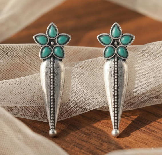 Flower Stud Silver Drop Earrings in Turquoise. Oxidised silver-finish earrings with a five-petal stone flower stud and a long textured teardrop drop with a beaded centre line.
