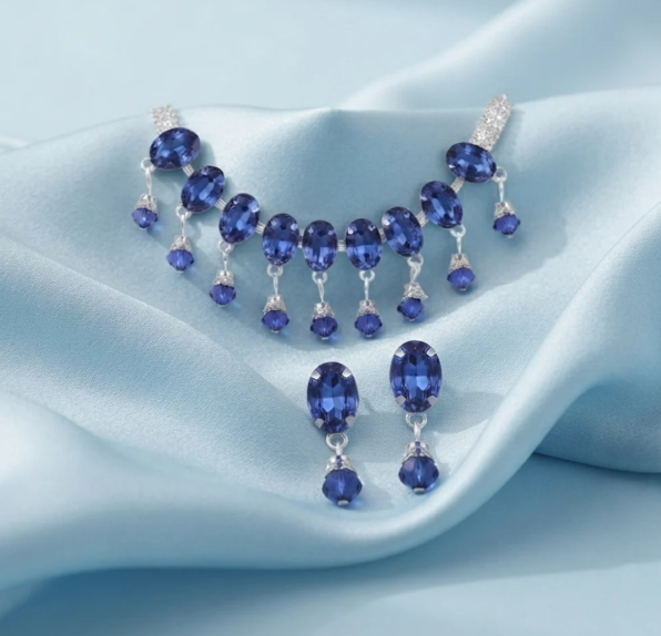 Sapphire Blue Drop Necklace Set. Rich sapphire-blue oval stones with dangling drops, paired with matching earrings.