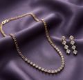 Rose Gold Crystal Half-Chain Necklace Set. Rose-gold curb chain leading into a crystal-studded front, with matching earrings.