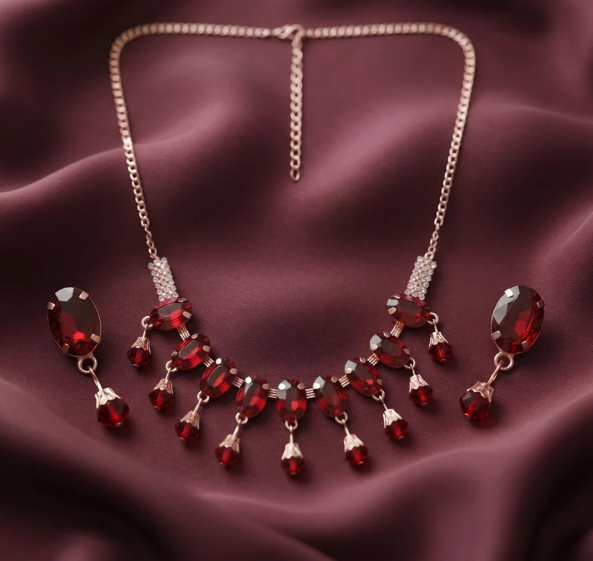 Ruby Red Drop Necklace Set. Ruby-red stones with a fringe of dangling drops and matching oval earrings.