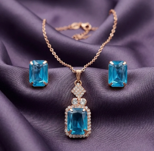 Aqua Blue Pendant Necklace Set. An emerald-cut aqua-blue pendant framed in crystals, with matching stud earrings.