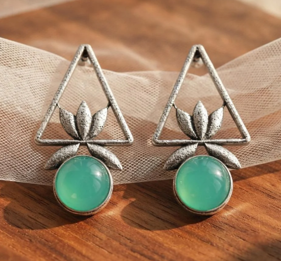 Triangle Lotus Drop Earrings in Aqua Green. Oxidised silver-finish earrings with an open triangle frame, sculpted lotus leaves and a round polished stone drop.